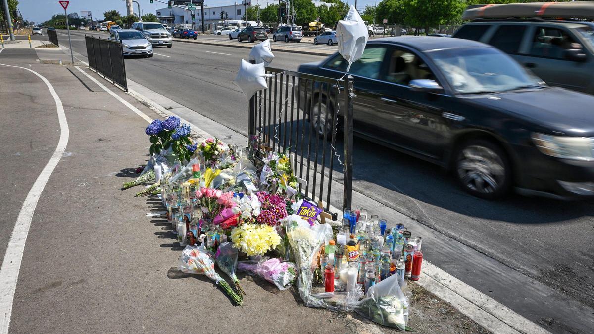 A memorial of flowers, candles and photographs that pay tribute to the victims of a fiery crash that occurred on Friday, May 2 at Clovis Avenue at Shields in Fresno appear at the scene, on Monday, May 5, 2025.