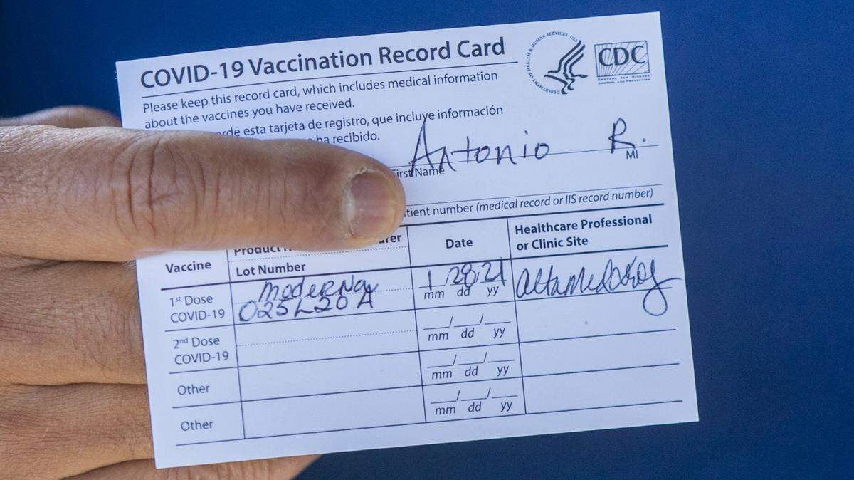 Former Los Angeles Mayor Antonio Villaraigosa holds his vaccination card after receiving his first shot of the Moderna COVID-19 vaccination in January 2021.