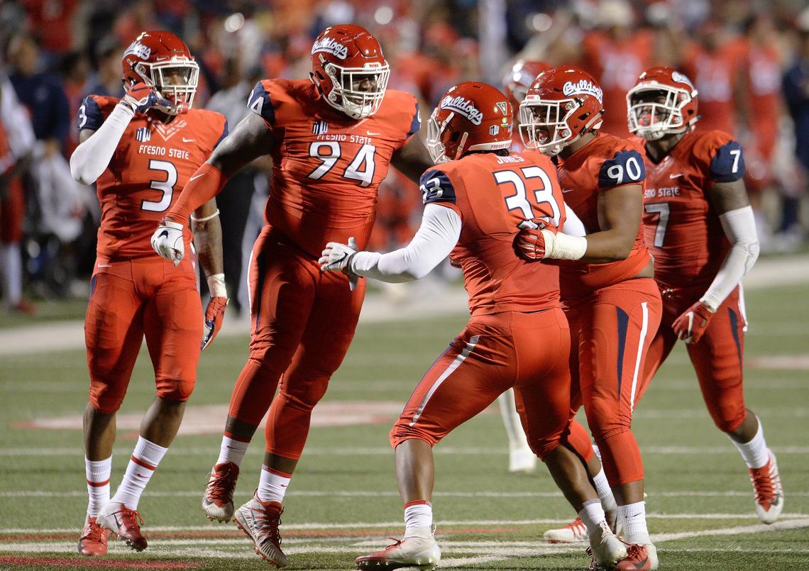 Fresno State’s defense celebrates a sack by Kwami Jones, center (33) during a 49-27 victory over the Toledo Rockets at Bulldog Stadium on Saturday, Sept. 29, 2018. The Bulldogs set season-highs with five sacks and nine tackles for loss.