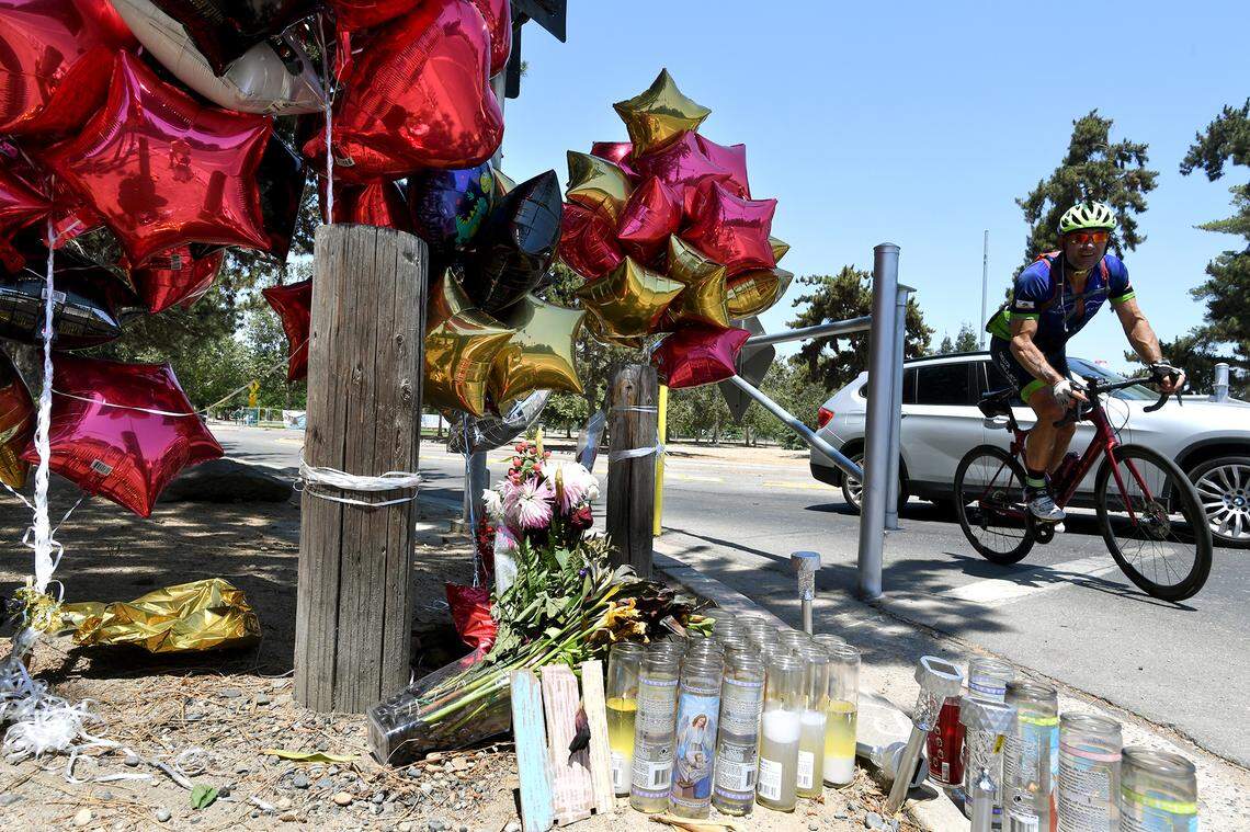 A memorial stands Saturday morning at the intersection of  North Friant Road at Fort Washington Road, on a corner of Woodward Park, paying tribute with flowers, candles, toys and messages for 10-year-old Angel Hernandez, who was killed in a hit-and-run&nbsp;late Thursday night, June 17, 2021. 