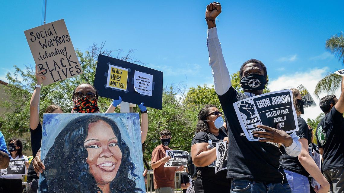 Victor Griffin, right, of the Fresno County Public Defender’s Office stands by Sabrina Brock, visiting from San Francisco, carrying a portrait of police shooting victim Breonna Taylor, during a peaceful protest in downtown Fresno organized by the public defender’s office to show solidarity with Black Lives Matter on Monday, June 8, 2020. A coordinated, nationwide effort was held by public defender’s offices across the country to confront systemic racism, inequity and police violence.
