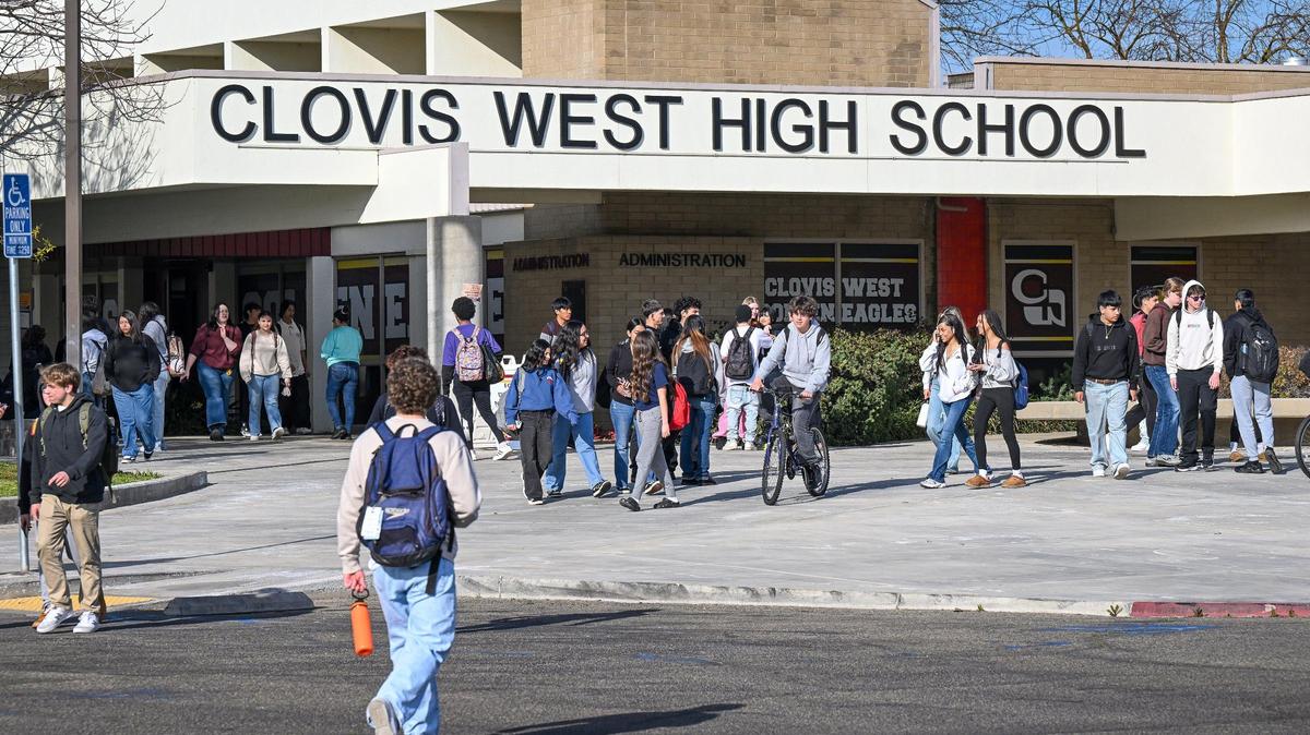 Students walk near the campus entrance following dismissal of classes at Clovis West High School on Tuesday, Feb. 18, 2025.