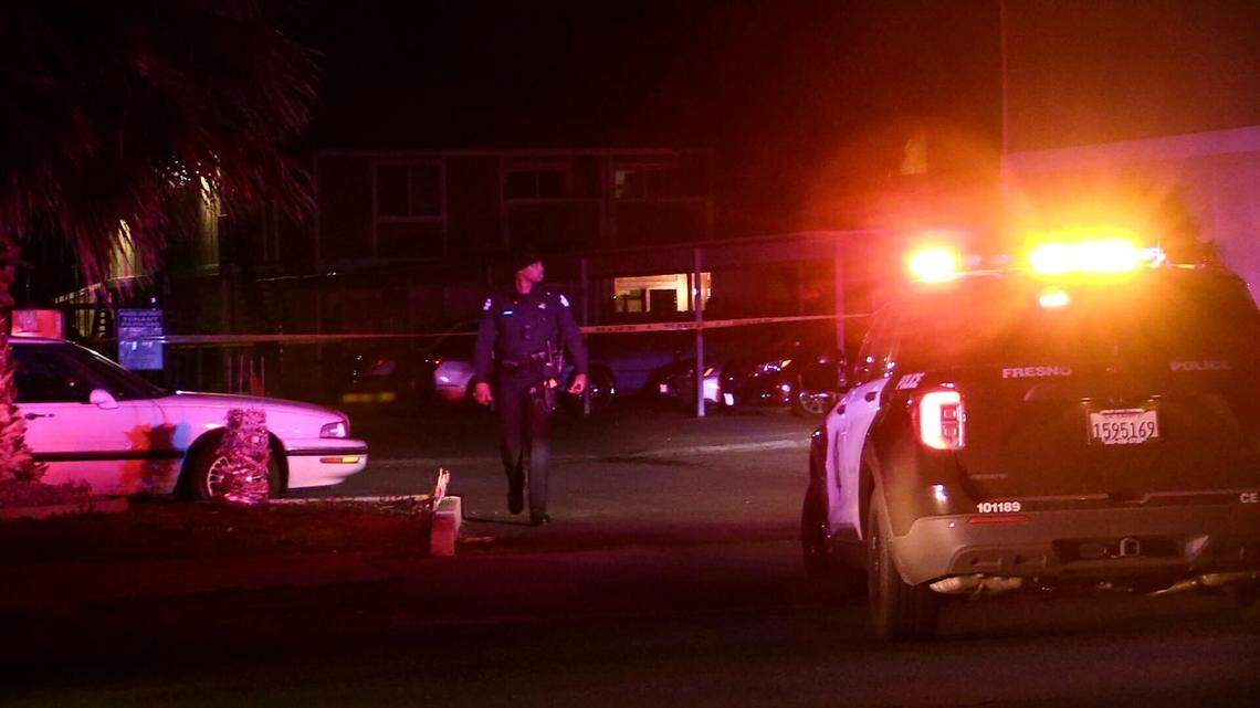 Officers investigate a scene where a woman was shot while standing outside with a group of people in west Fresno on Saturday, Feb. 18. 2023.