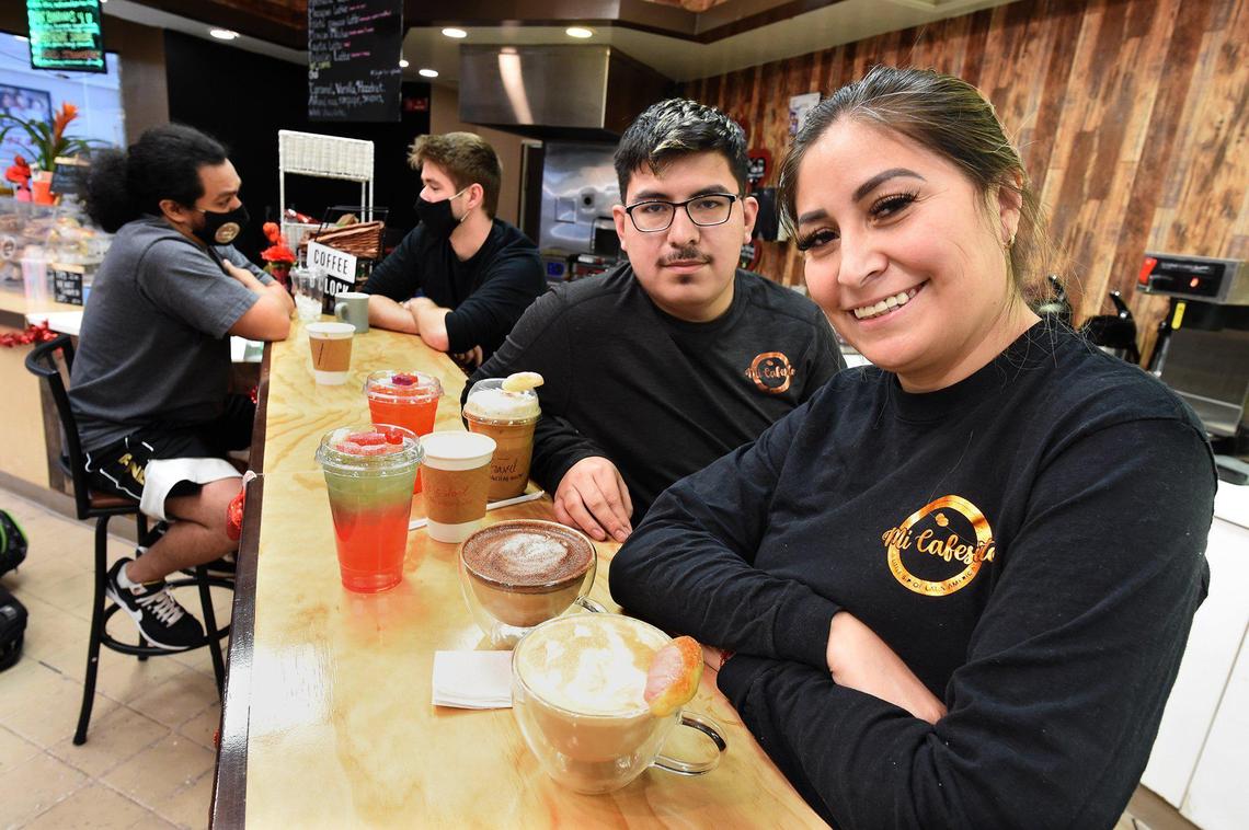 Evelyn Gutierrez, owner of Mi Cafesito, a Latin America-themed coffee shop in Manchester Mall, with her son, Hassan Macedo, who works at the shop. They offer coffee from several Latin America countries, as well as healthy energy drinks.