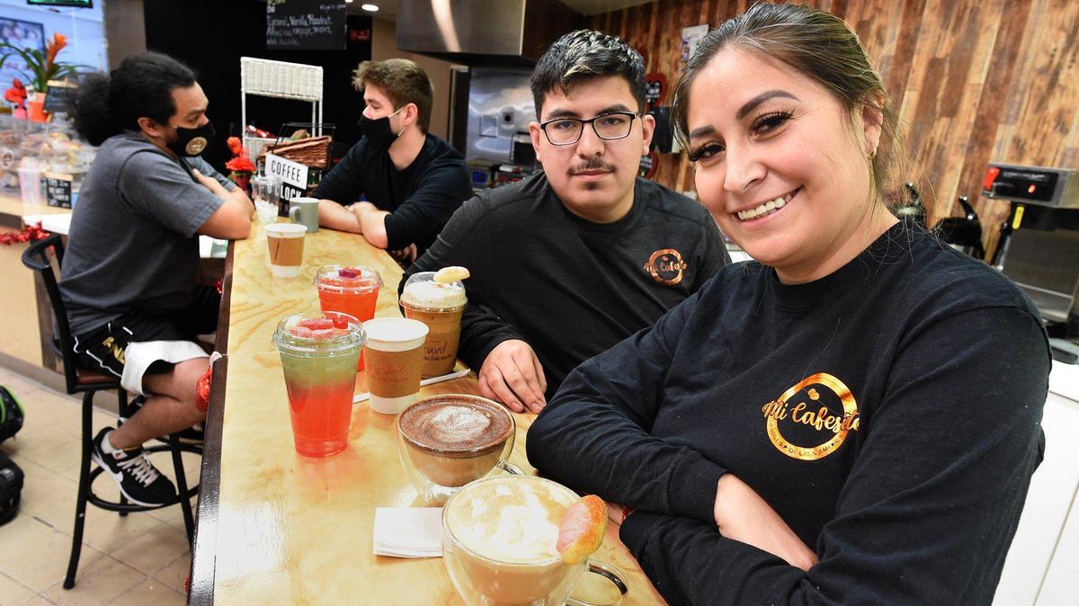 Evelyn Gutierrez, owner of Mi Cafesito, a Latin America-themed coffee shop in Manchester Mall, with her son, Hassan Macedo, who works at the shop. They offer coffee from several Latin America countries, as well as healthy energy drinks.