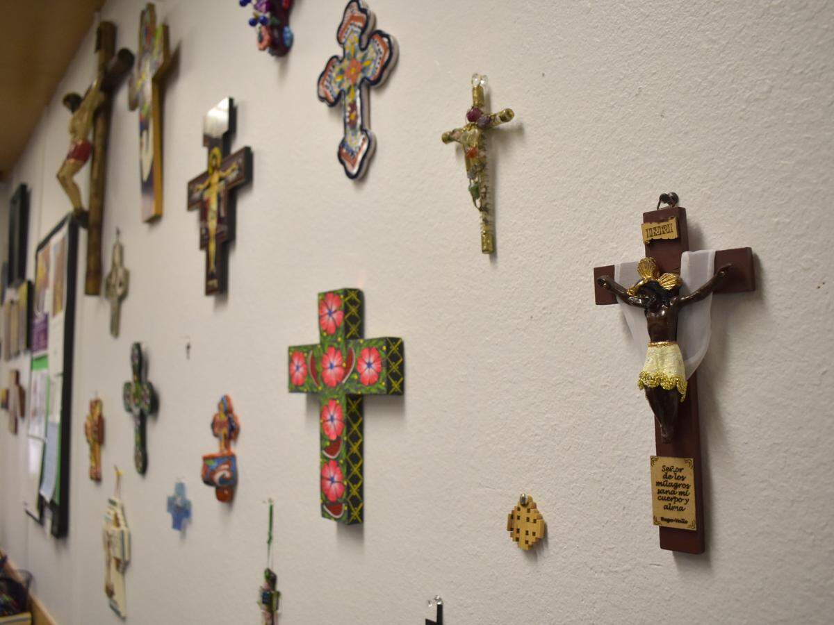 Crucifixes and crosses made in different countries hang on the wall in Rev. Nelson Serrano Poveda’s office at Fresno’s St. James Episcopal Cathedral.