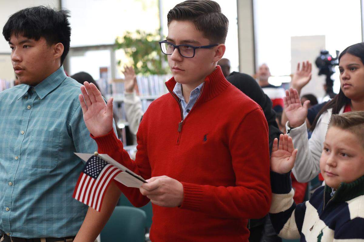 Among the newest citizens are the brothers Antonio José Álvarez Coss (center) y León, 14 and Juan Pablo Álvarez Coss y León, 10, (right) from Visalia during the U.S. Citizenship and Immigration Services (USCIS) Special Children’s Ceremony Thursday afternoon at the Delano Branch Library.