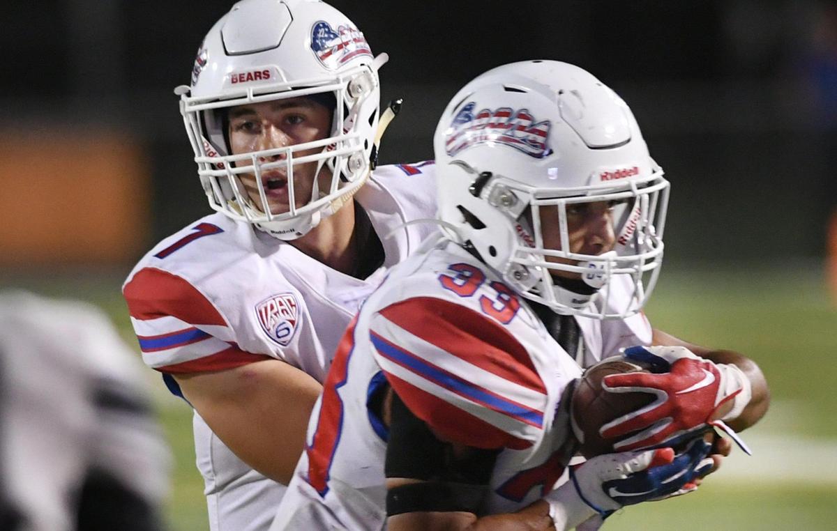 Buchanan quarterback Jayden Mandal hands off to Michael Runnels in the Bears’ 49-41 win against Central Friday, Oct. 7, 2022 in Fresno.