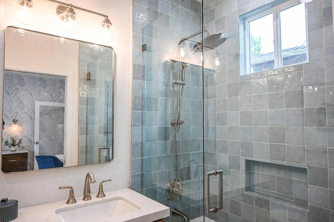 A bathroom space is shown at a recently completed accessory dwelling unit or ADU sitting adjacent to a house on a lot in Fresno neighborhood. Property owner Brandon Telesmanic had the home built as a rental property which is a growing trend in Fresno.