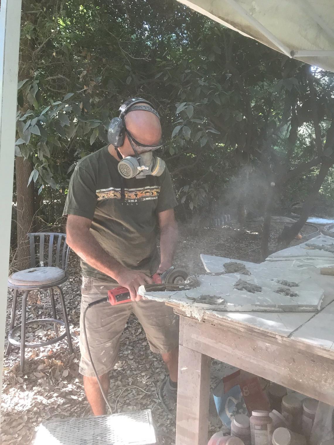 Fresno artist David Roberts works on the valley oak mural created by himself and Manchester GATE sixth-grade students.