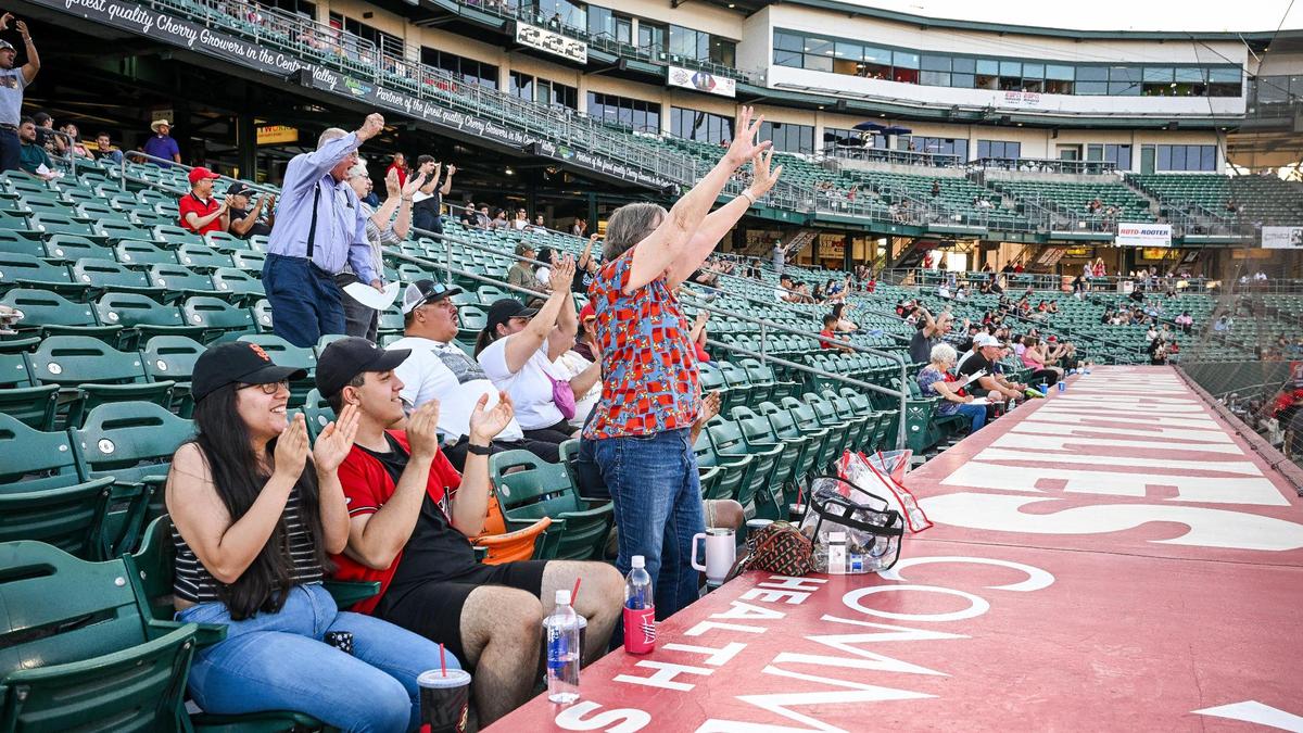 Fans cheer on the Fresno Grizzlies baseball team during a game against the Modesto Nuts at Chukchansi Park in downtown Fresno Wednesday, June 11, 2025.