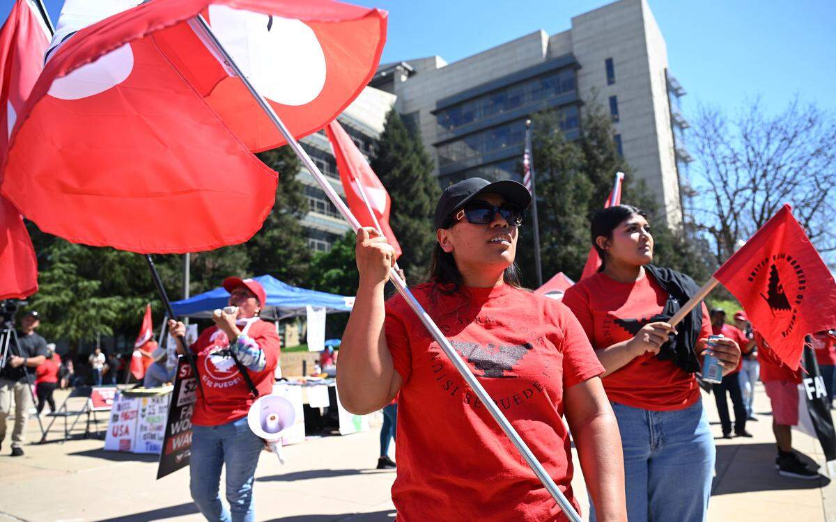 Protesters rally outside the Robert E. Coyle Federal Courthouse to voice opposition to a proposed change in pay for guest workers Wednesday, March 18, 2026 in downtown Fresno.