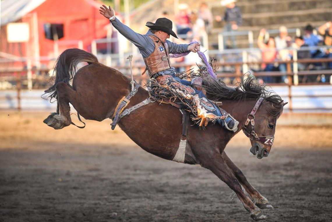 Teagan Smith rides Strawberry Rocket in the saddle bronc riding section of the PRCA event at the Clovis Rodeo on Thursday, April 23, 2021.