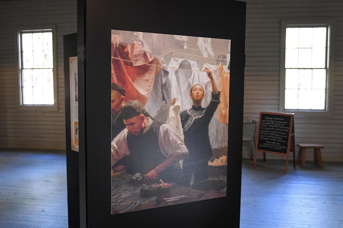A print of a painting by artist Mian Situ is displayed among other artifacts illustrating the nature of work once done in the Chinese Laundry Building near the Yosemite History Center in Yosemite’s Wawona on Tuesday, Sept. 28, 2021. The building is being dedicated in honor of its original purpose as a laundry building for the Wawona Hotel and the Chinese immigrants who ran it.