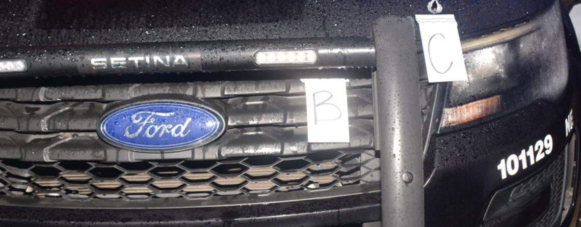 Markers show where a Fresno police vehicle was struck by gunfire during what officers said was an exchange of shots with a suspect Saturday.