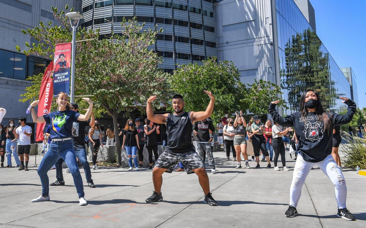 Fresno State students dance during a noontime event called “Bulldogs Joyful Together” on campus near the Henry Madden Library on Wednesday, Sept. 8, 2021.