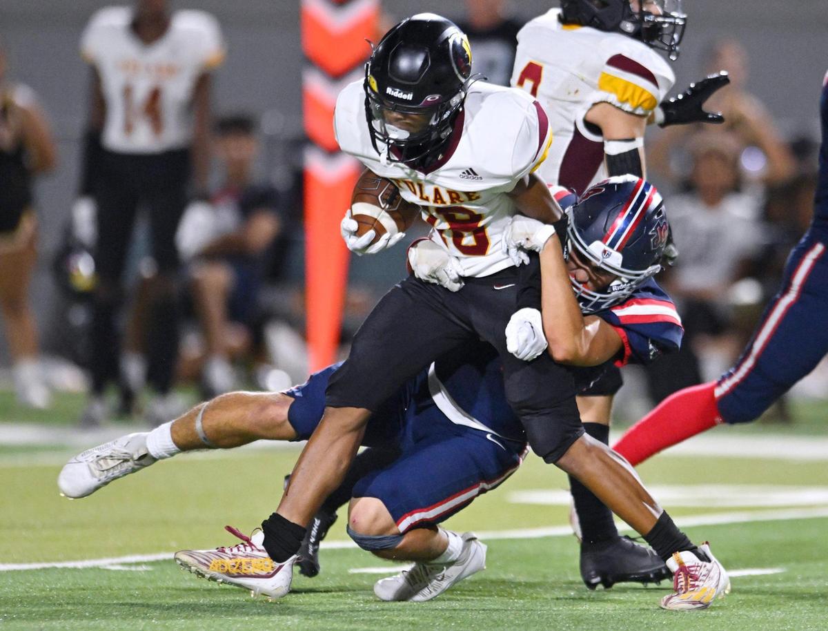 Garza’s Trent Aguilar, background, tackles Tulare Union’s Demaje Riley Thursday, Sept. 7, 2023 in Fresno.