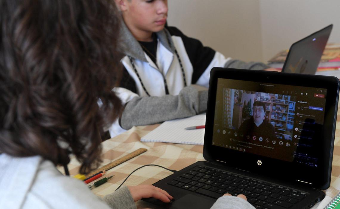 Lizette Pacheco, a Duncan Polytechnical High School student, left, and her brother, Ahwahnee Middle School student Sebastian Pacheco, attend class sessions during distance learning at home, Thursday Nov. 19, 2020, due to the Covid-19 pandemic.
