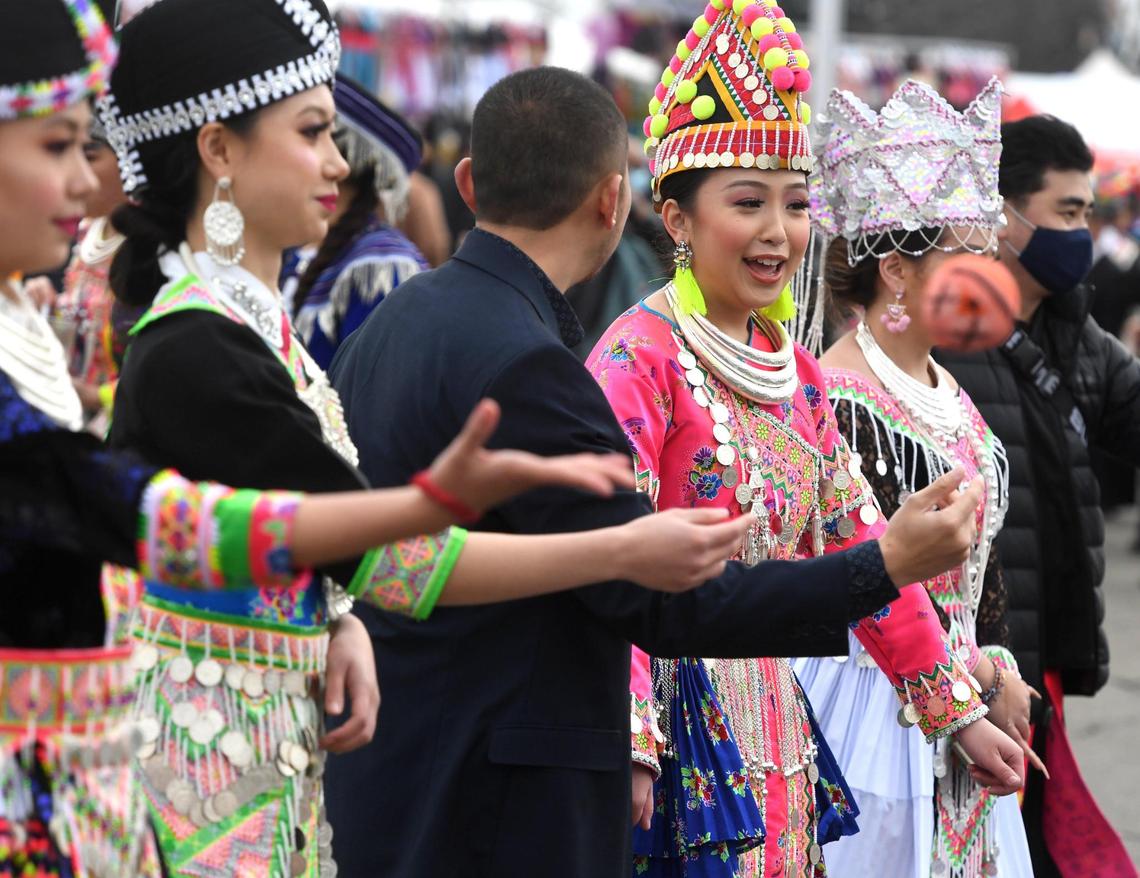 Young people socialize during the traditional courtship game of Pov Pob, during the Hmong New Year celebration at the Fresno Fairgrounds, Thursday morning, December 30, 2021.