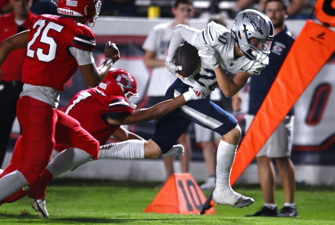 Clovis East’s Elijah Wilson, right, fights for yardage against Sanger Friday, Sept. 6, 2024 in Sanger. Final score, Clovis East 56, Sanger, 3.