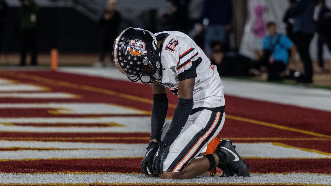 The Central Grizzlies’ Xavior Jones (15) kneels dejectedly after missing a touchdown catch against Edison High School of Huntington Beach during the CIF State Division 1-A championship at Saddleback College in Mission Viejo on Saturday.