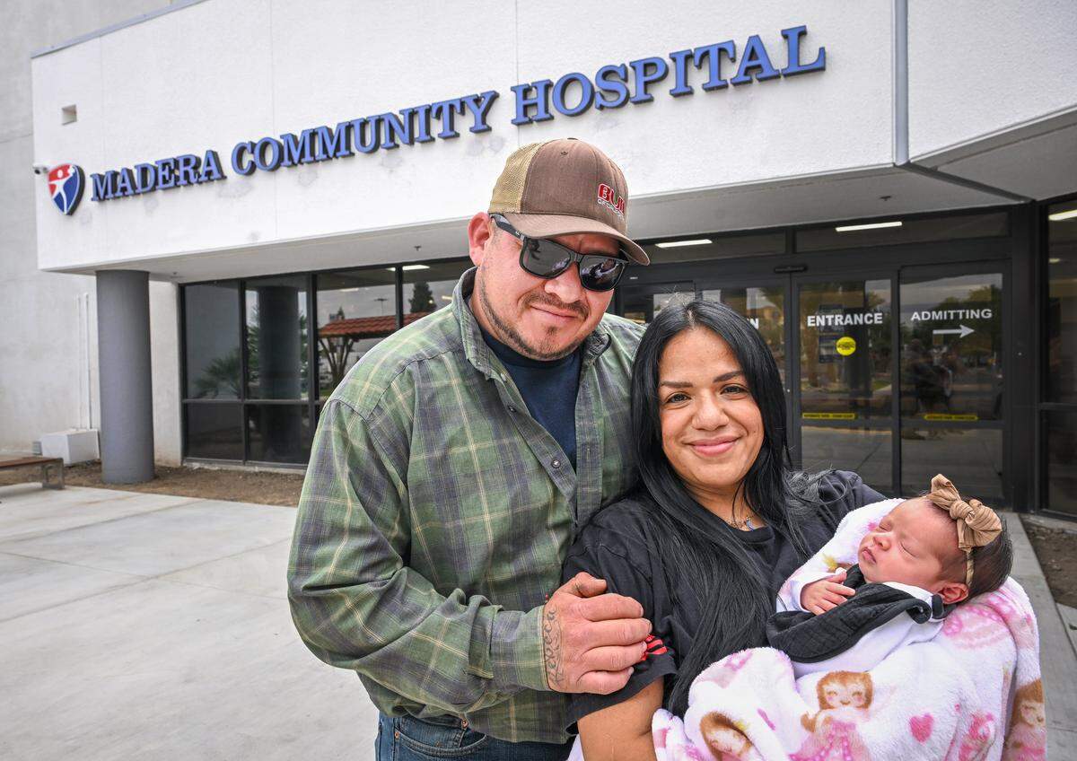 Rebeca Cervantes and her husband Javier Bautista stand with their baby Haven Bautista Cervantes outside Madera Community Hospital on Sept. 24, 2025. The Madera couple said they would be unable to make it to Saint Agnes in Fresno in time so they rushed to the Madera hospital where their daughter was delivered with help from hospital staff on Sept. 8, 2025. 