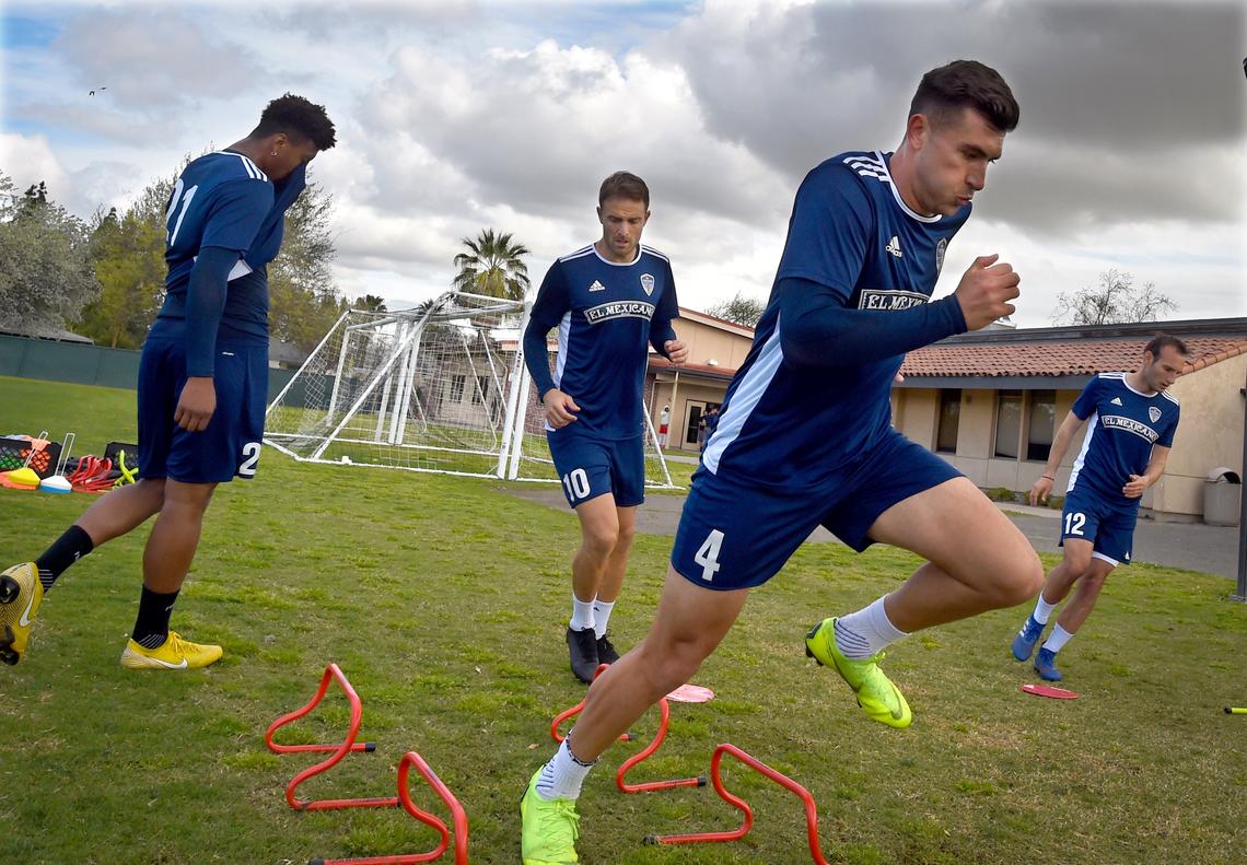 Fresno Fox player Ramon M. Del Campo, center right, and teammates run through drills at Fresno City College, Mar. 20, 2019, in preparation for their season home opener at Chukchansi Park this Saturday.