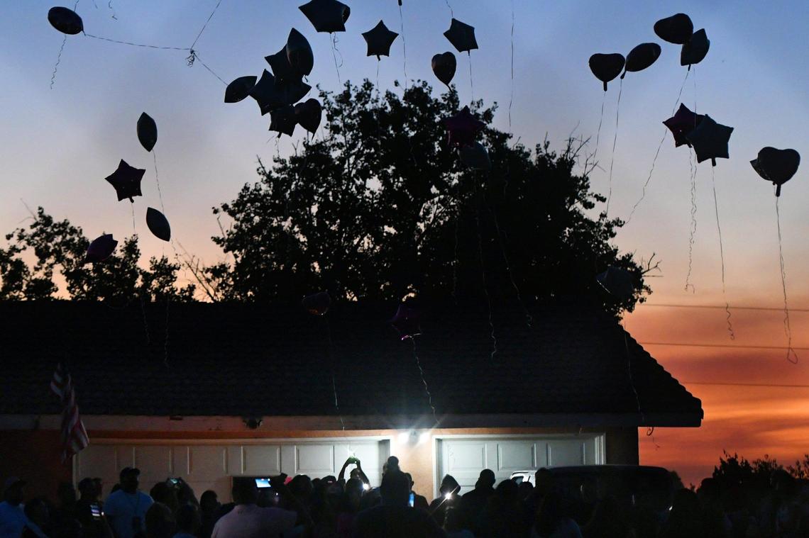 Balloons are set free at a vigil which brought about 100 people to memorialize Yanelly Solorio Rivera, 18, and her 3-week-old girl, Celine Solorio Rivera on Tuesday evening, Sept. 27, 2022 south of Fresno. The two died after being shot at their rural home Saturday. Police are still searching for the killer.