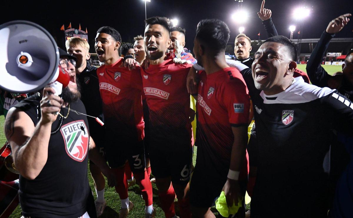 Central Valley Fuego FC players sing with fans after the home opener against Greenville Triumph SC Saturday night, May 7, 2022 in Fresno.