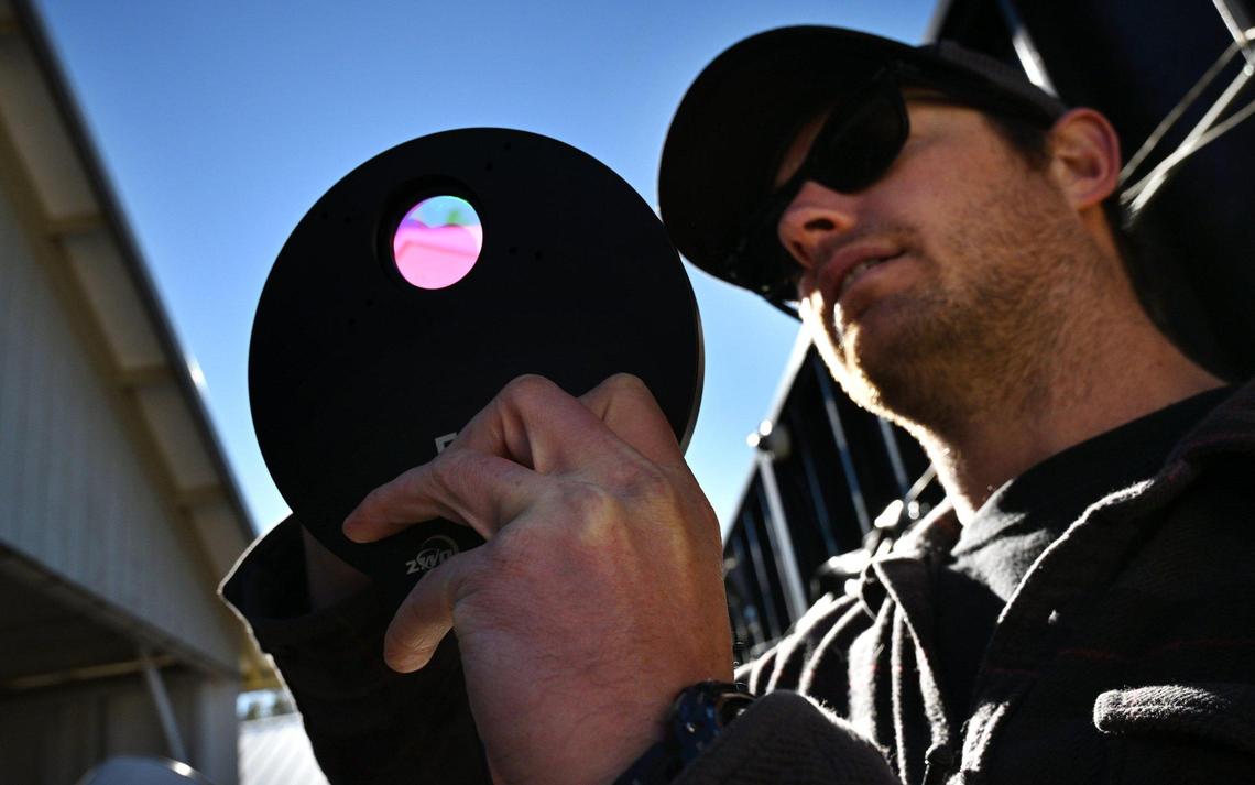 Sierra Remote Observatory technician Sam Miller shows off a colored filter wheel he uses to help in clarity for captured images from his telescope at the hilltop observatory. Photographed Tuesday, Jan. 21, 2025 near Auberry.