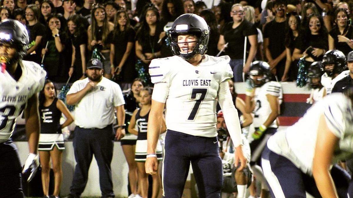 Clovis East quarterback Ty Miller looks over the line of scrimmage during a football game against Sanger on Friday, Sept. 2, 2022.