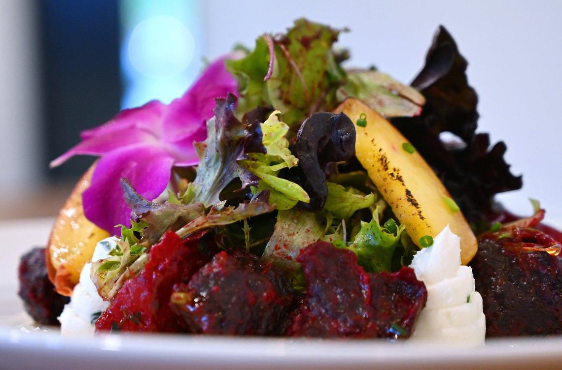 The roasted beet and peach salad at The Third Place Global Eatery features roasted beets, charred peaches and a spring salad drizzled with house-made beet dressing.
