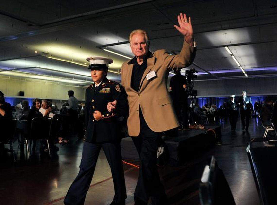 Bob Fraley is escorted in as a past inductee (class of 2008) at the 2014 Fresno Athletic Hall of Fame enshrinement dinner. The former Fresno State track and field coach is co-author of a new student-athlete journal, “Searching for Victory.”