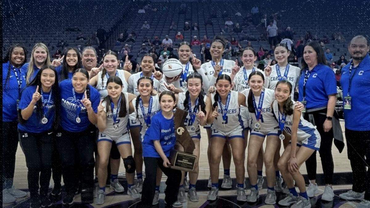 The Caruthers High girls basketball team poses for a photo after winning the CIF Division III state championship in Sacramento on Friday, March 8, 2024.
