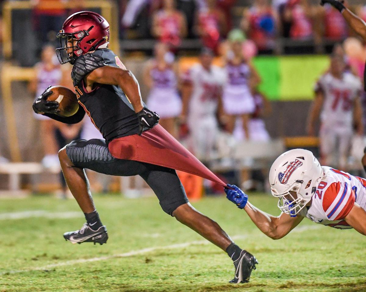 Clovis West’s Landon Wright runs after making a long catch and run before being pulled down from behind by Buchanan’s Josh Wilson during their game at Lamonica Stadium in Clovis on Friday, Sept. 30, 2022.