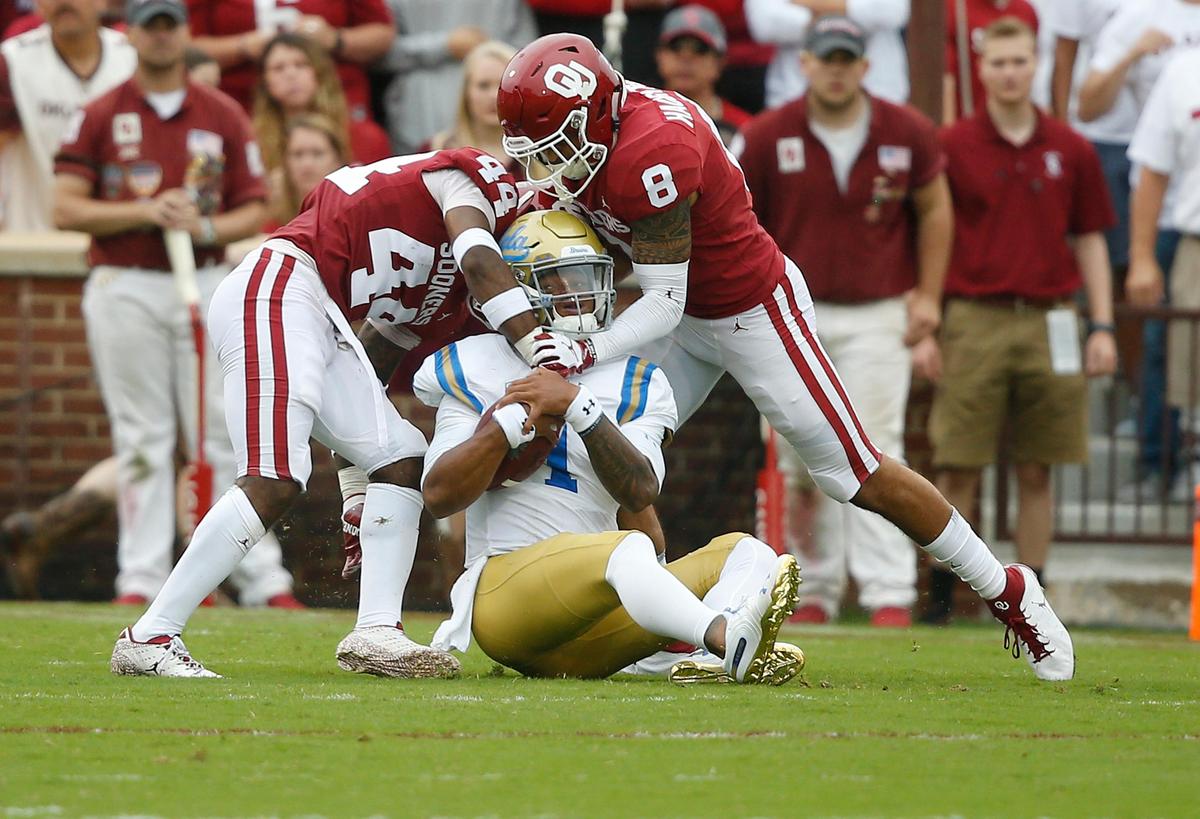 Oklahoma defensive back Brendan Radley-Hiles (44) and safety Kahlil Haughton (8) sack UCLA quarterback Dorian Thompson-Robinson (7) during a 49-21 victory over the Bruins in Norman, Okla., Saturday, Sept. 8, 2018. Oklahoma had six sacks in the win.