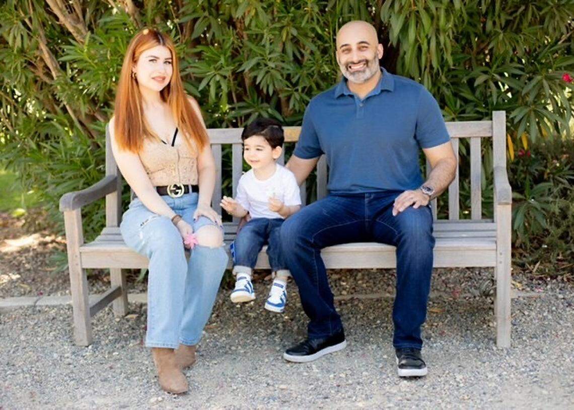 Psalm Behpoor, 42, sits with his wife, Lera Mirakyan, and 3-year-old son, Psalm Wally, in an undated photo. Behpoor remains in custody nearly two months after being detained by U.S. Immigration and Customs Enforcement on June 23, 2025.