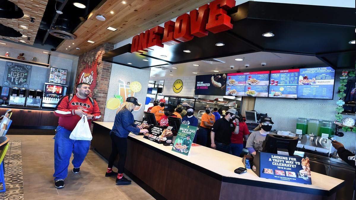 A customer leaves Raising Canes Chicken Fingers, after the Tuesday morning ribbon-cutting opening, at the site of the old Logans Roadhouse, Blackstone and El Paso avenues, March 8, 2022.