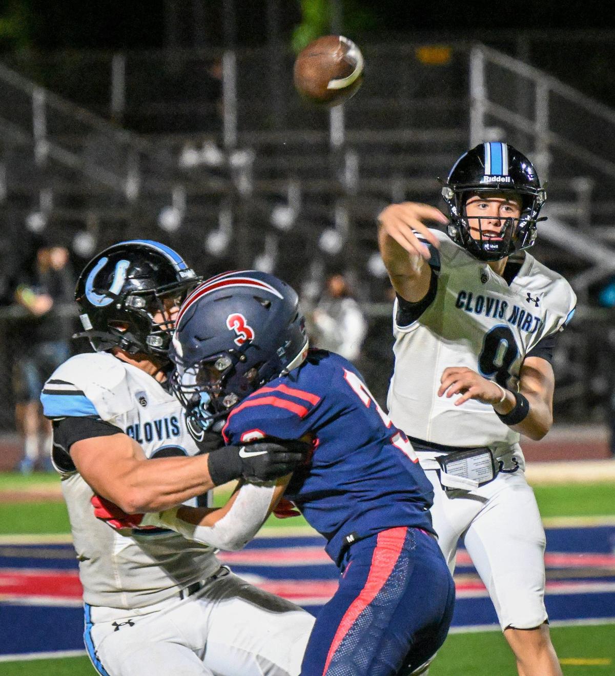 Clovis North quarterback Lucas Smith, right, throws downfield while getting some blocking help against Memorial during their game at San Joaquin Memorial on Friday, Aug. 23, 2024.