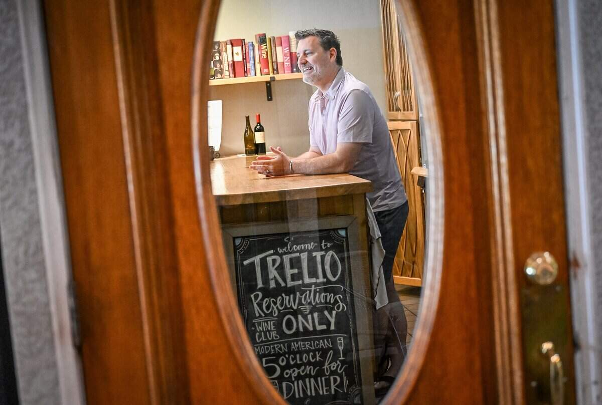 Chris Shackelford, owner of Trelio in Old Town Clovis, is photographed through the door while at the wine bar of the restaurant on Monday, June 1, 2026. The boutique restaurant is celebrating 20 years in business.