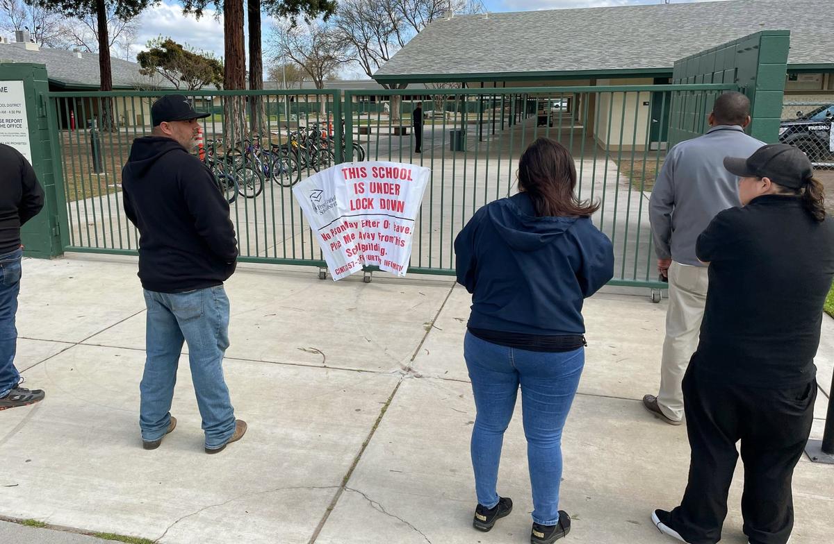 Worried parents gather outside Herbert Hoover High School after a hoax call from outside the area forced a lockdown Friday around noon, March 24, 2023 in Fresno.