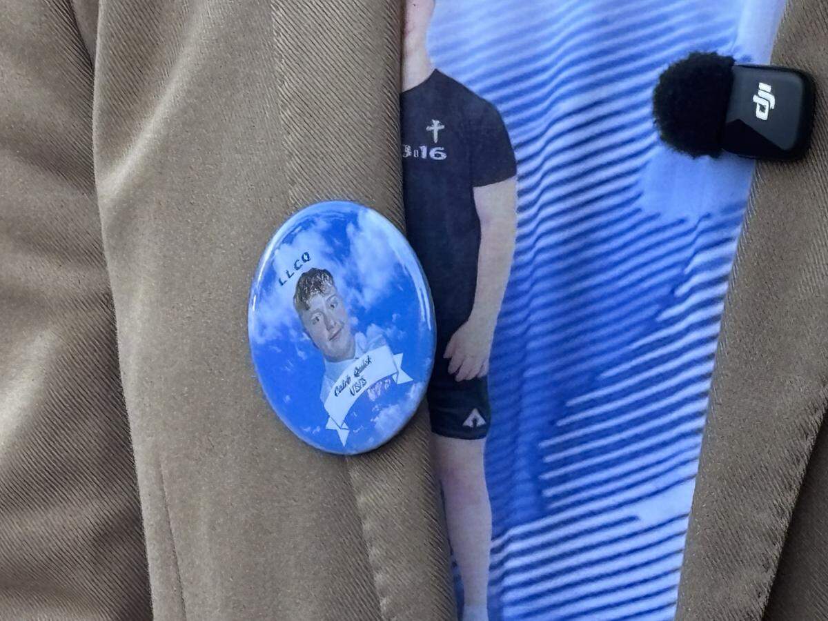 Stephen Quick, the father of Caleb Quick, wears a button while he speaks to media outside the Fresno County Courthouse on Friday, May 15, 2026, after a judge decided one of the two teens accused of killing his son will remain in the juvenile justice system.