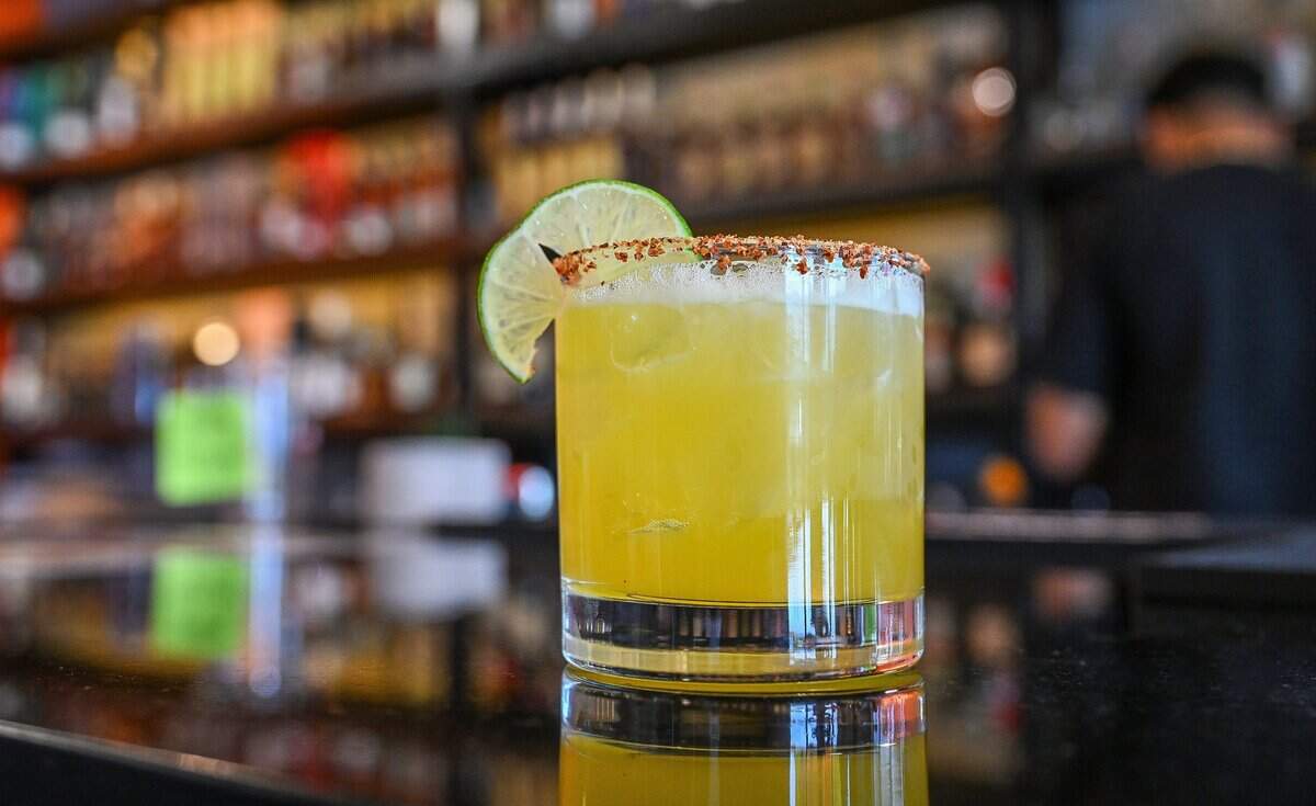 A Sunnyside Spice specialty cocktail, described as sweet, tangy and spicy, is ready to drink at The Curry Pizza Company's newest location on Fowler south of Belmont in southeast Fresno on Tuesday, June 9, 2026. This one has a full bar.