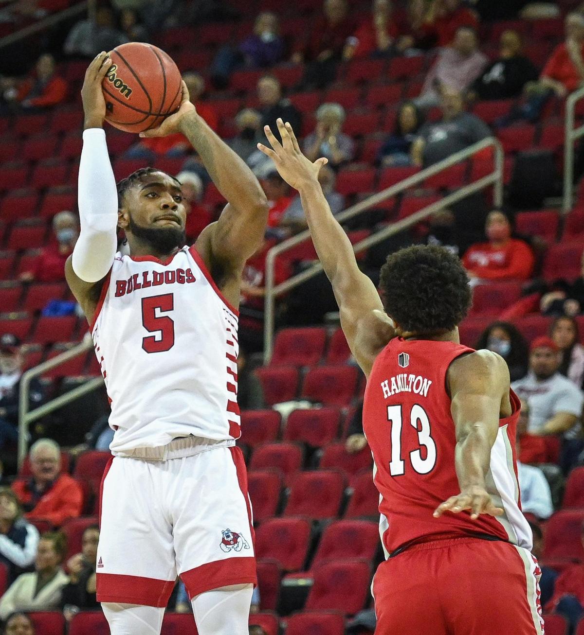 Fresno State’s Jordan Campbell, left, lines up a shot while defended by UNLV’s Bryce Hamilton during their game at the Save Mart Center in Fresno on Wednesday, Feb. 16, 2022.