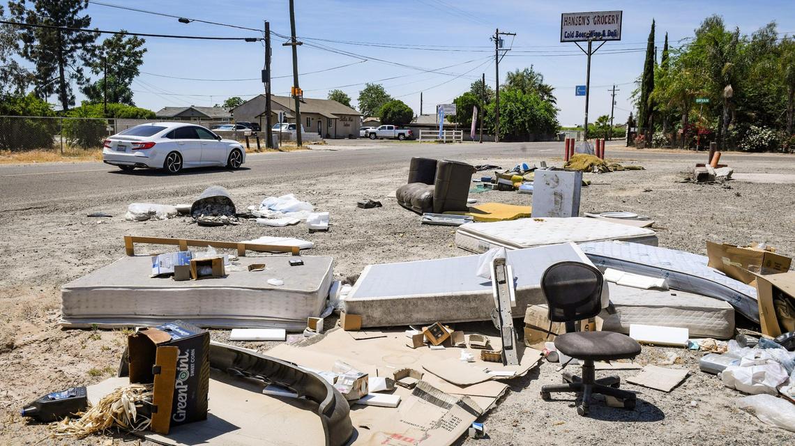 An illegal dump, including appliances, mattresses, computer equipment, furniture and chemical containers, is shown strewn along the roadside at the corner of McKinley Avenue at Bryan west of Fresno on Friday, April 30, 2021.