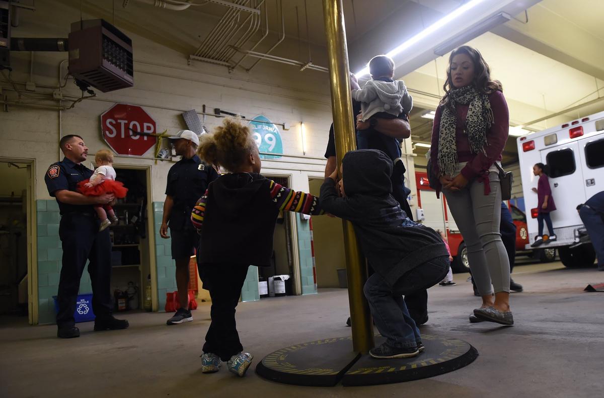 Siblings play at Fresno Fire Station 3 in downtown Fresno, Monday, Nov. 12, 2018. A number of firefighters have recently had babies.