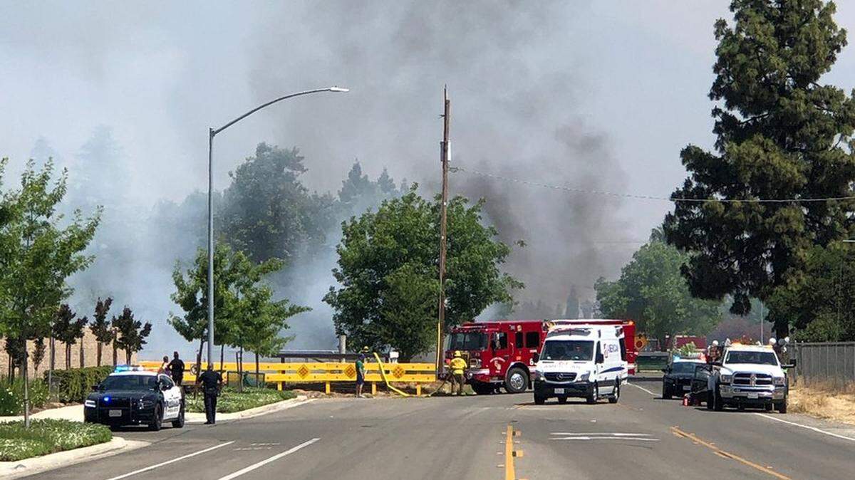 A single-car accident at Bullard and De Wolf avenues in Clovis knocked down power lines and started a small grass fire Sunday, May 16, 2021.
