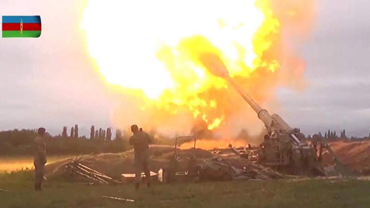 A video still shows members of Azeri armed forces firing artillery during clashes between Armenia and Azerbaijan over the territory of Nagorno-Karabakh in an unidentified location, from footage released Sept. 28.