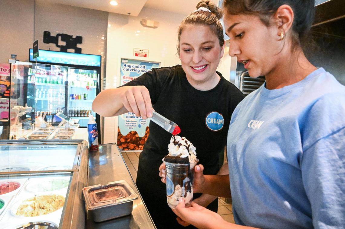 Amanda Vogel and her daughter Jazmyn Sandhu, 12, put the finishing touches on a brownie and ice cream sundae at CREAM in the Bulldog Plaza shopping center near Fresno State.