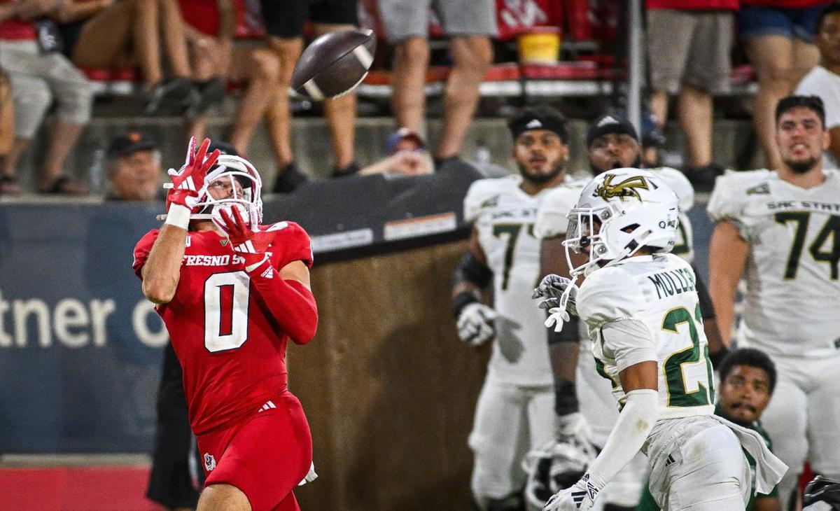 Fresno State’s Mac Dalana, left, hauls in a long throw from quarterback Mikey Keene against Sacramento State at Valley Children’s Stadium in Fresno on Saturday, Sept. 7, 2024.